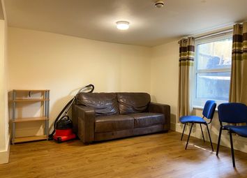 A Cozy Living Room With A Brown Sofa, Two Blue Cha...