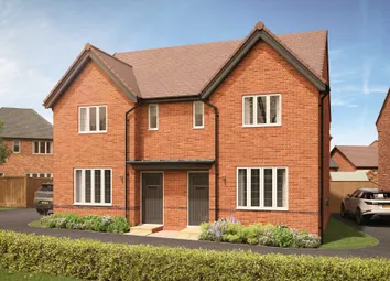 A Modern Brick Semi-Detached House With Manicured Hedges In The Foreground And A Clear Blue Sky With