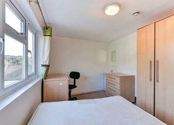 A Well-Lit And Tidy Bedroom With A Large Window Pr...