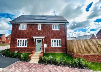 A Modern Red Brick House With A Light Blue Door Stands In The Foreground