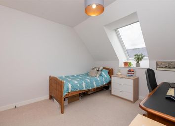 A Neat And Bright Single Bedroom Featuring A Comfo...