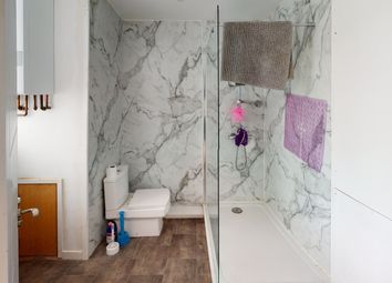 A Modern Bathroom Featuring Marble Walls And A Cle...