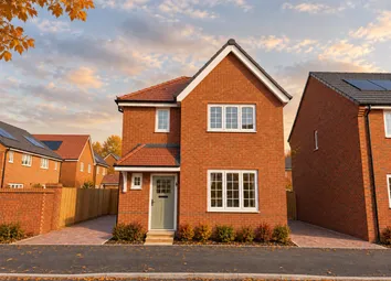 A Modern Red-Brick House With A Grey Door Stands In The Foreground Against A Backdrop Of Similar Hom