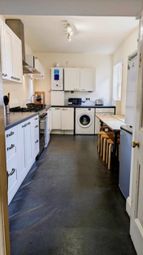 A Spacious And Bright Kitchen Featuring Modern App...