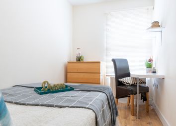 A Cozy Double Bedroom Featuring A Comfortable Bed,...