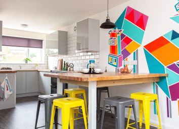A Modern Kitchen Featuring Vibrant Wall Art And A ...