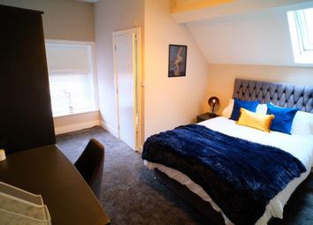 A Cozy Master Bedroom Featuring A Stylish Upholste...