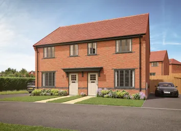 A Pair Of Modern Brick Semi-Detached Houses With Manicured Lawns And Driveways Sit Under A Bright Bl