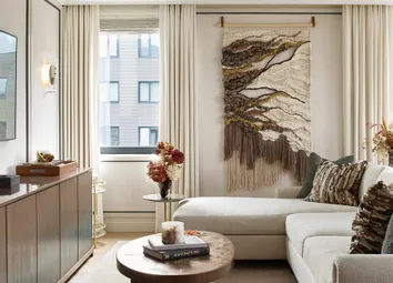 Modern Designed Living Space With Wall-Mounted TV, Sofa And Coffee Table.
