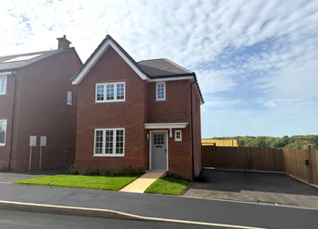 A Modern Red Brick House With A Neat Lawn In The Foreground Sits Before A Wooden Fence And A Treelin