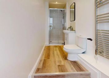 A Modern And Clean Bathroom Featuring A Shower And...