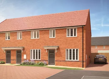 A Row Of Modern Brick Townhouses With Red Tile Roofs Stands On A Paved Driveway