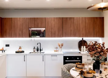 Decorated Dining Table, Clock And Wall Hanging, Kitchenette With Wood-Finish Cupboards, White