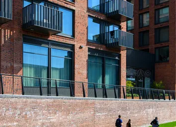 Exterior View Of Canal And Walkway In The Sun, With New Build Flats Alongside.