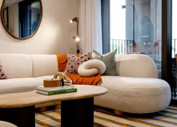 Closeup Photo Of Bevelled Coffee Table, L-Shaped Sofa, Next To Balcony