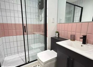 A Modern And Stylish Bathroom Featuring A Spacious...
