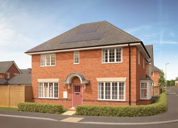 A Brick House With A Pink Door And Manicured Hedges In The Foreground Sits Under A Bright Blue Sky W