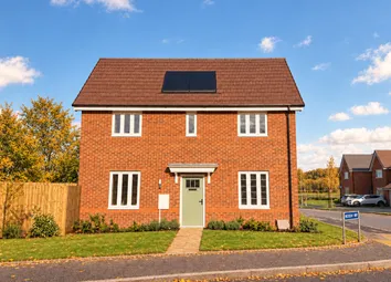 A Two-Story Red Brick House With A Green Front Door And Solar Panels Sits Behind A Green Lawn And Wo