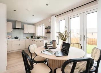 A Modern Kitchen And Dining Area With French Doors To The Rear Garden