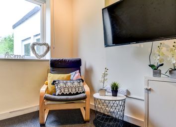 A Cozy And Well-Maintained Living Room Featuring A...