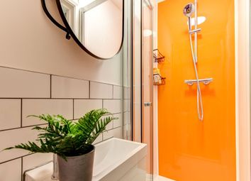This Modern Bathroom Features A Bright Orange Acce...