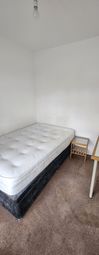 A Simple, Tidy Single Bedroom Featuring A Comforta...