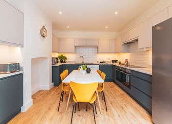 A Modern And Bright Kitchen Featuring Ample Space ...