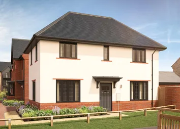 A White Two-Story House With A Dark Tiled Roof And Brick Accents Stands Behind A Small Garden With F
