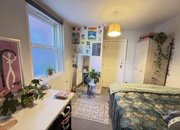 A Spacious And Well-Lit Bedroom Featuring A Large ...