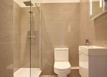 A Modern And Clean Bathroom Featuring A Shower And...