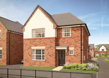 A Modern Brick House With A White Gabled Facade Stands Behind A Black Metal Fence And A Landscaped G