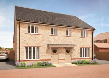 A Pair Of Modern Brick Semi-Detached Houses With Neat Gardens And A Car Parked In The Driveway Are S