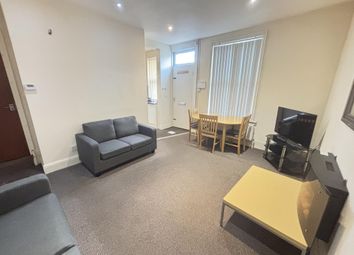 A Spacious And Well-Lit Living Room Featuring Comf...