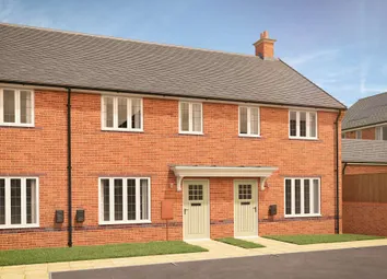 Two Identical Brick Townhouses With White-Framed Windows And Light Green Doors Stand On A Paved Walk