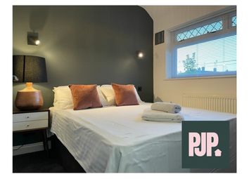 A Stylish And Inviting Double Bedroom With Ample N...