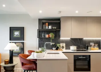 View Of Kitchenette With Attached Island And Living Space Adjacent.