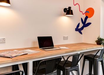 Bright And Inviting Communal Workspace Featuring A...