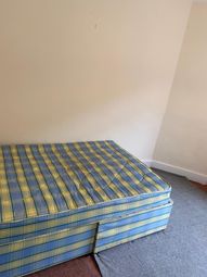 A Simple Single Bedroom Featuring A Patterned Matt...