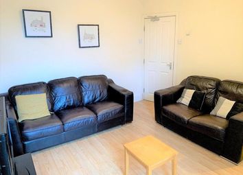 A Cozy And Inviting Living Room Featuring Comforta...