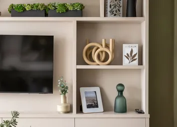 Closeup Of A Wall Mounted TV Unit With Shelving And Drawers, Decorated In Off-White Tones Adjacent