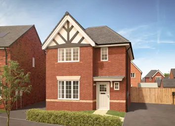 A Red Brick House With White-Trimmed Windows And A White Door Stands In The Foreground