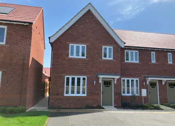 A Row Of Modern Brick Townhouses With White-Framed Windows And Red Tile Roofs Stands Under A Bright