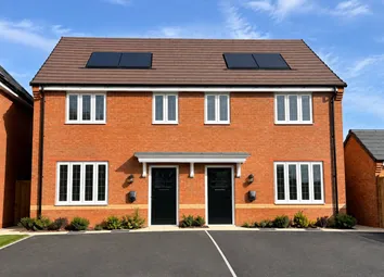A Two-Story Red Brick Semi-Detached House With Black Doors And Solar Panels Sits Behind A Paved Driv