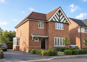 A Two-Story Brick House With A Distinctive Tudor-Style Facade