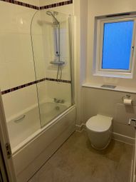 A Modern Bathroom Suite Featuring A Clean White Ba...