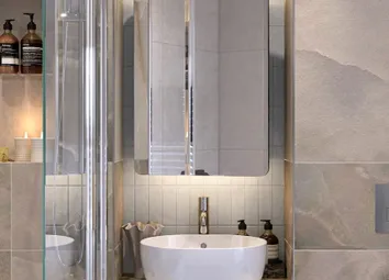 Bathroom With Shower Over Bath, Wash Basin With Cabinet Mirror And Shelving.