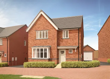 A Red Brick House With A Bay Window And White Door Sits Behind A Neatly Trimmed Hedge