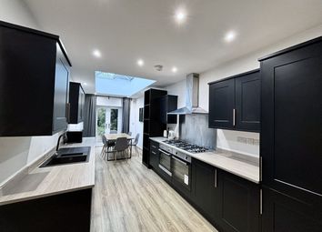 A Modern And Spacious Kitchen Featuring Sleek Blac...