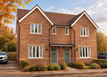 A Two-Story Red Brick Semi-Detached House With Green Doors Stands Behind A Leaf-Strewn Driveway And