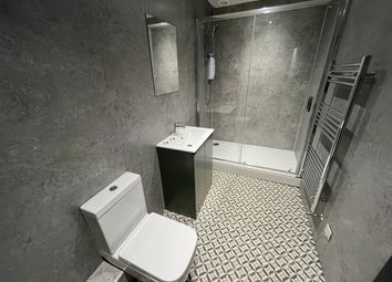 A Modern And Stylish Bathroom Featuring A Spacious...